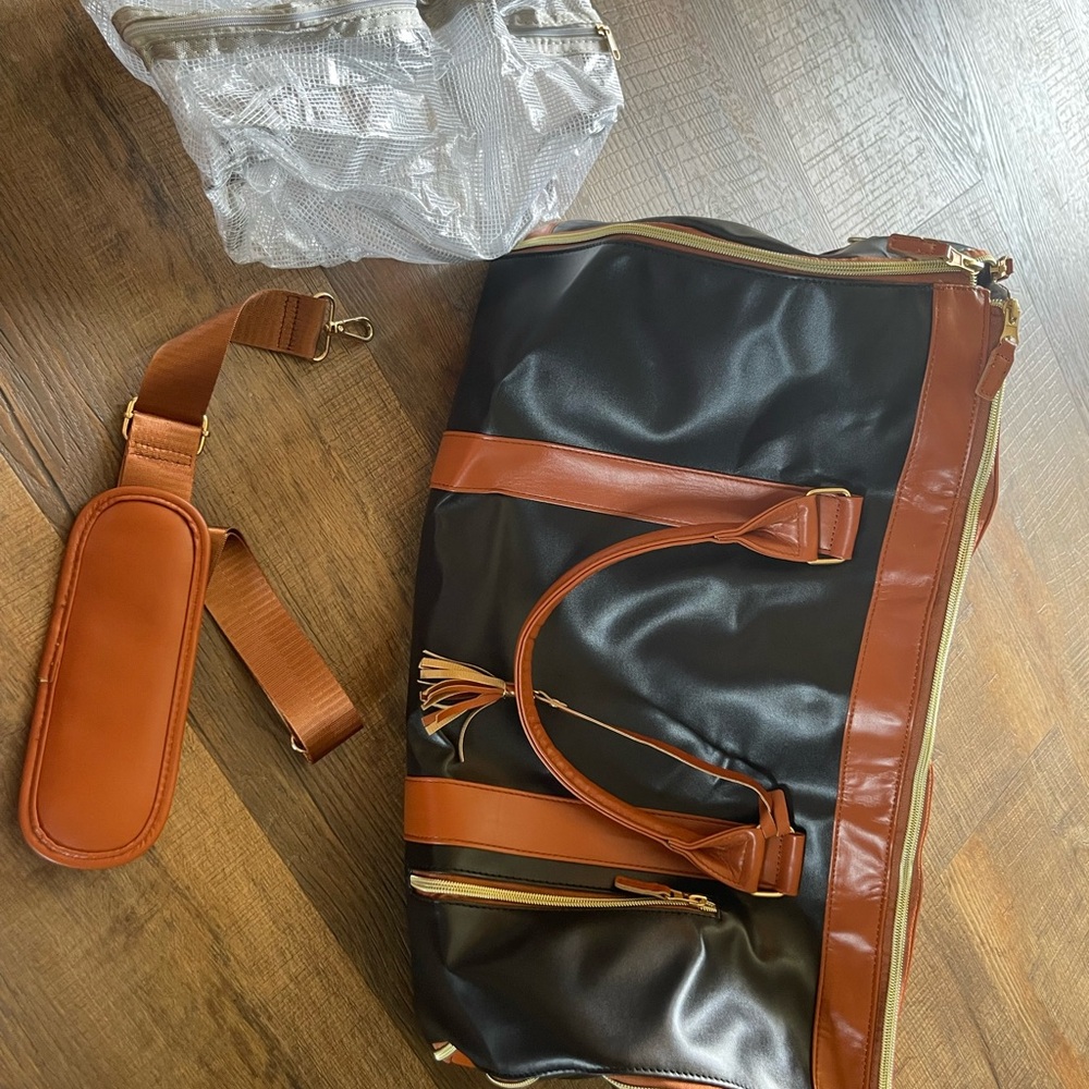 Elegant Black and Brown Leather Duffel Bag with Polished Finish